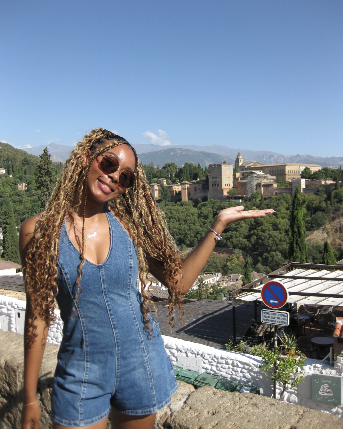 This is me and the Alhambra in the background. The Alhambra is a stunning palace and fortress complex in Granada, Spain.