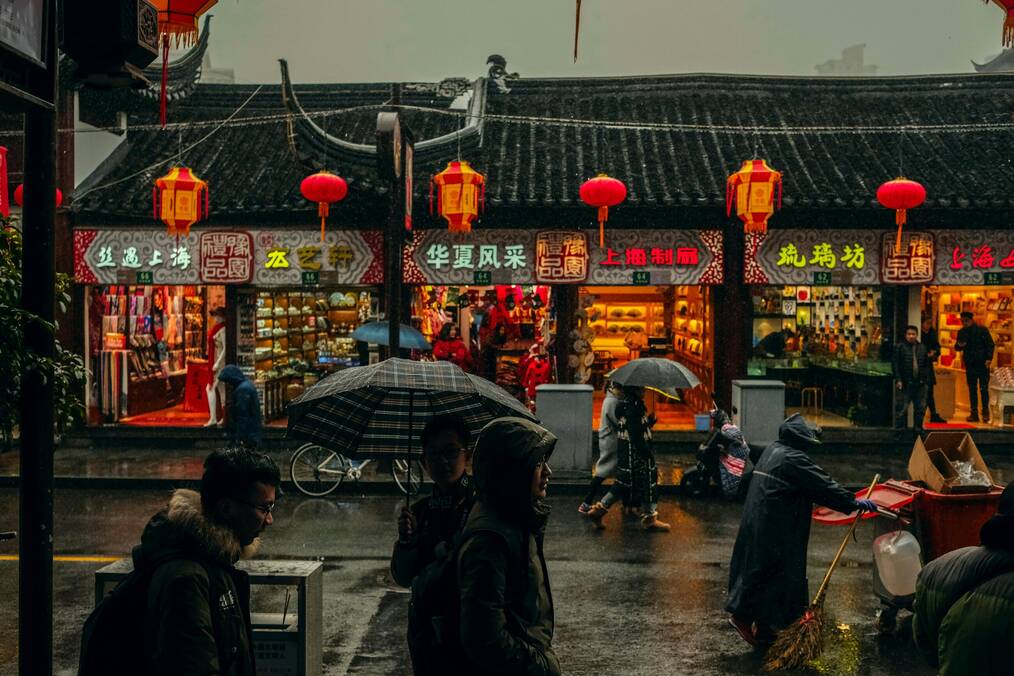 A lit up street in China on a rainy day
