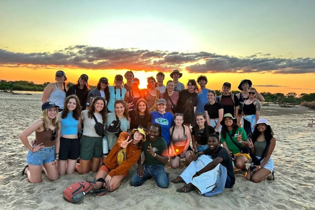 A group of friends on the beach during sunset