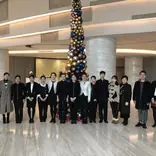 Law interns taking a group photo with co-workers in the hall
