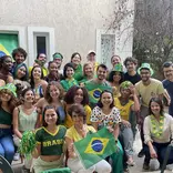 Students, faculty, and staff posing for a photo during a World Cup 2022 watch party
