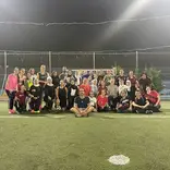 Students and local jiran posing for a photo after playing a pickup game of soccer