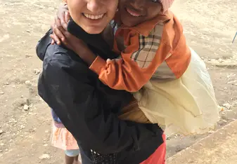Volunteer holding girl