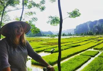 Girl on bicycle in Rice Field
