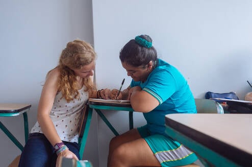 Teaching intern assisting child 