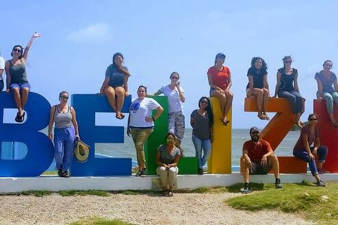 people around a Belize Sign