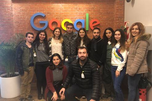 group of participants in front of google sign 