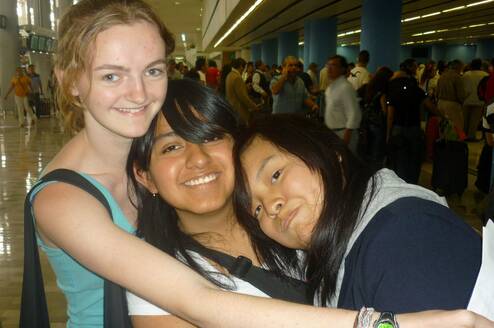 American intern hugging Mexican friends