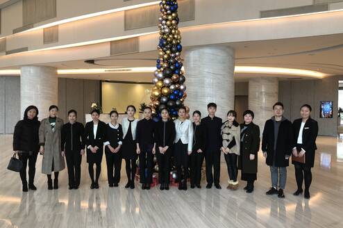 Law interns taking a group photo with co-workers in the hall