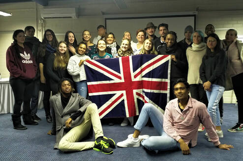 Graduates pose in front the British flag in Cape Town