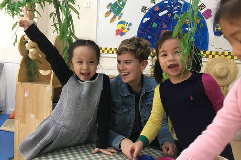 Kindergarten Chinese students with a female American teacher