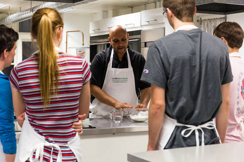 Teenagers listening to chef