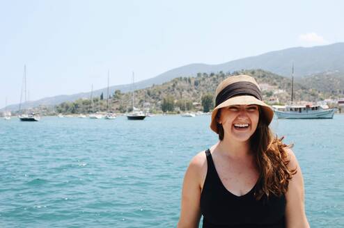 Student smiling in front of water