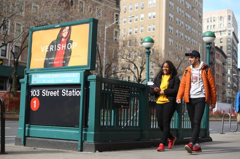 Two NYLC students walk near an NYC subway station