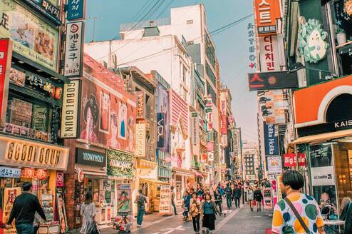 A busy street scene with colorful buildings and signs