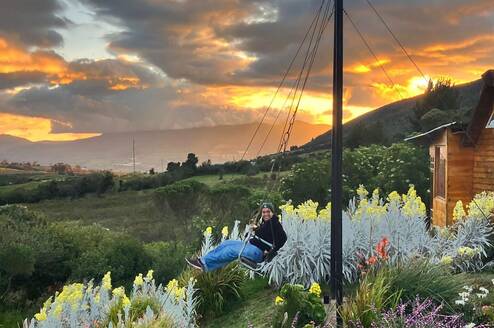 Ecuador intern on a swing enjoying sunset