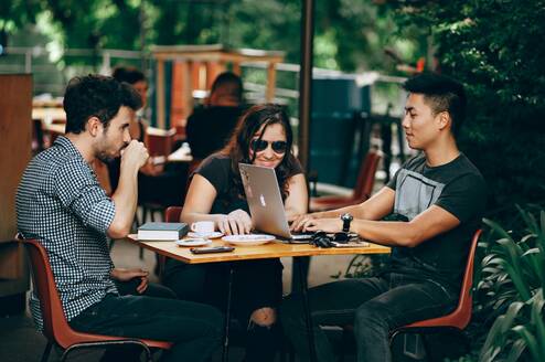 A group of digital nomads working at a cafe