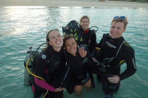 Divers pose in a pool