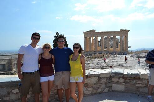 Students smiling in front of the Parthenon