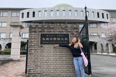 Student pointing to a sign at a university in Japan