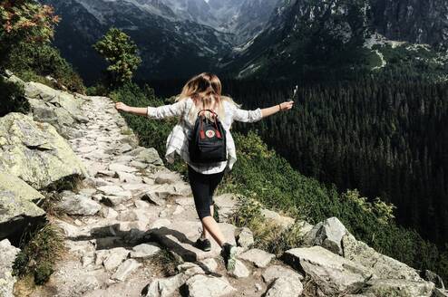 A girl walking through the moutains