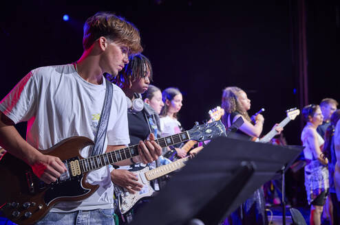 Participants playing musical instruments during concert