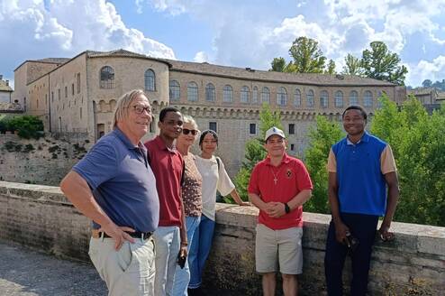 Students with the renowned Ducal Palace of Urbania in the background