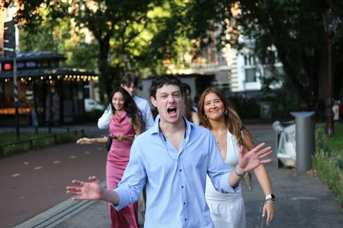 Students walking through Amsterdam on their way to the graduation photoshoot during their study abroad program.