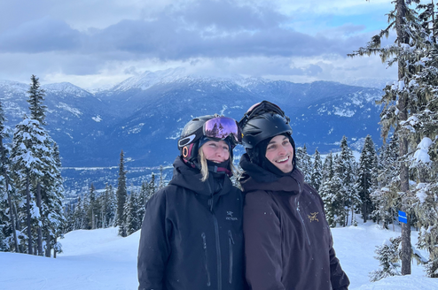 Two people on a snowy mountain with ski gear on