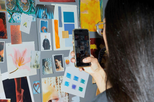 Student taking photo of mood board