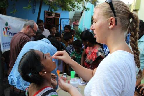 Volunteer gives a child vitamins
