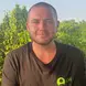 Matt Craig wearing a black GVI shirt with a green logo