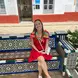 Lily smiles while sitting on decorative stairs
