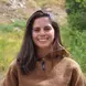 Woman smiling at the camera in the wilderness