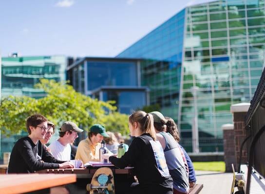 Students on campus outside a cafe