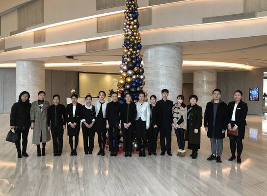 Law interns taking a group photo with co-workers in the hall
