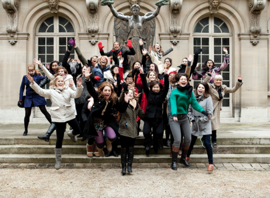 Group of students jumping during trip to Paris