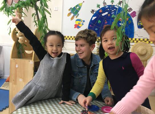 Kindergarten Chinese students with a female American teacher