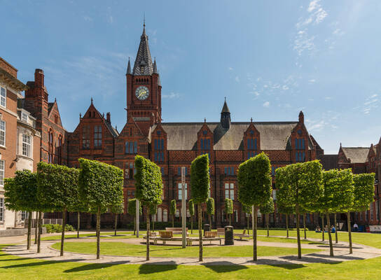 University of Liverpool campus surrounded by green trees & grass and our historic red brick buildings