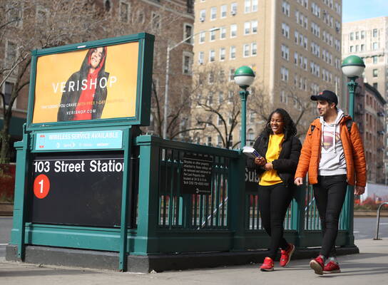 Two NYLC students walk near an NYC subway station