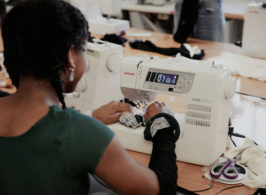 Student using sewing machine