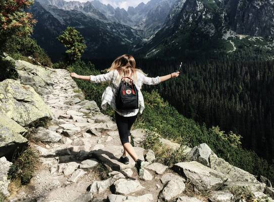 A girl walking through the moutains
