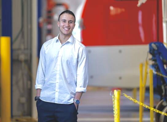 Young male intern smiles for the camera