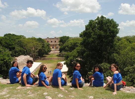 Students looking over ruins in Merida