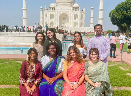 Students pose in front of the Taj Mahal.
