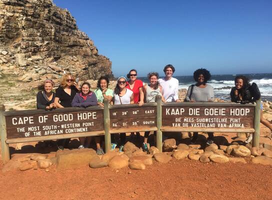 Students pose at Cape of Good Hope sign.