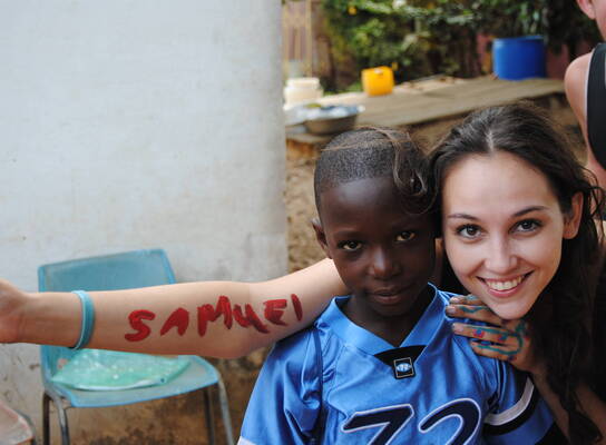Teacher with students in Ghana