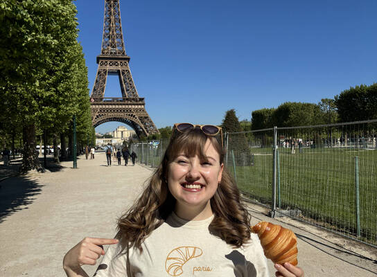 Woman standing beside eiffel tower