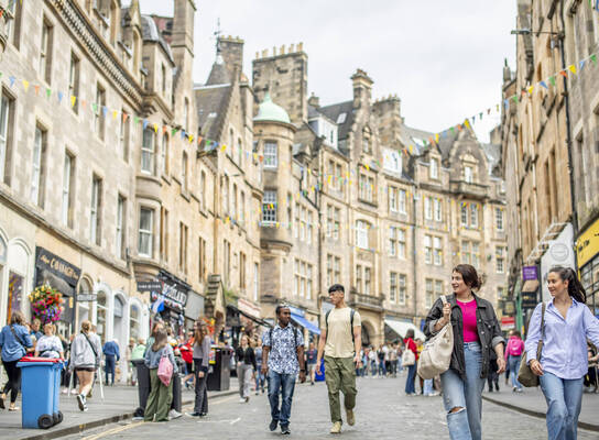 Students exploring Cockburn Street in Edinburgh's old town