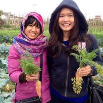 child and girl holding plants in Vietnam